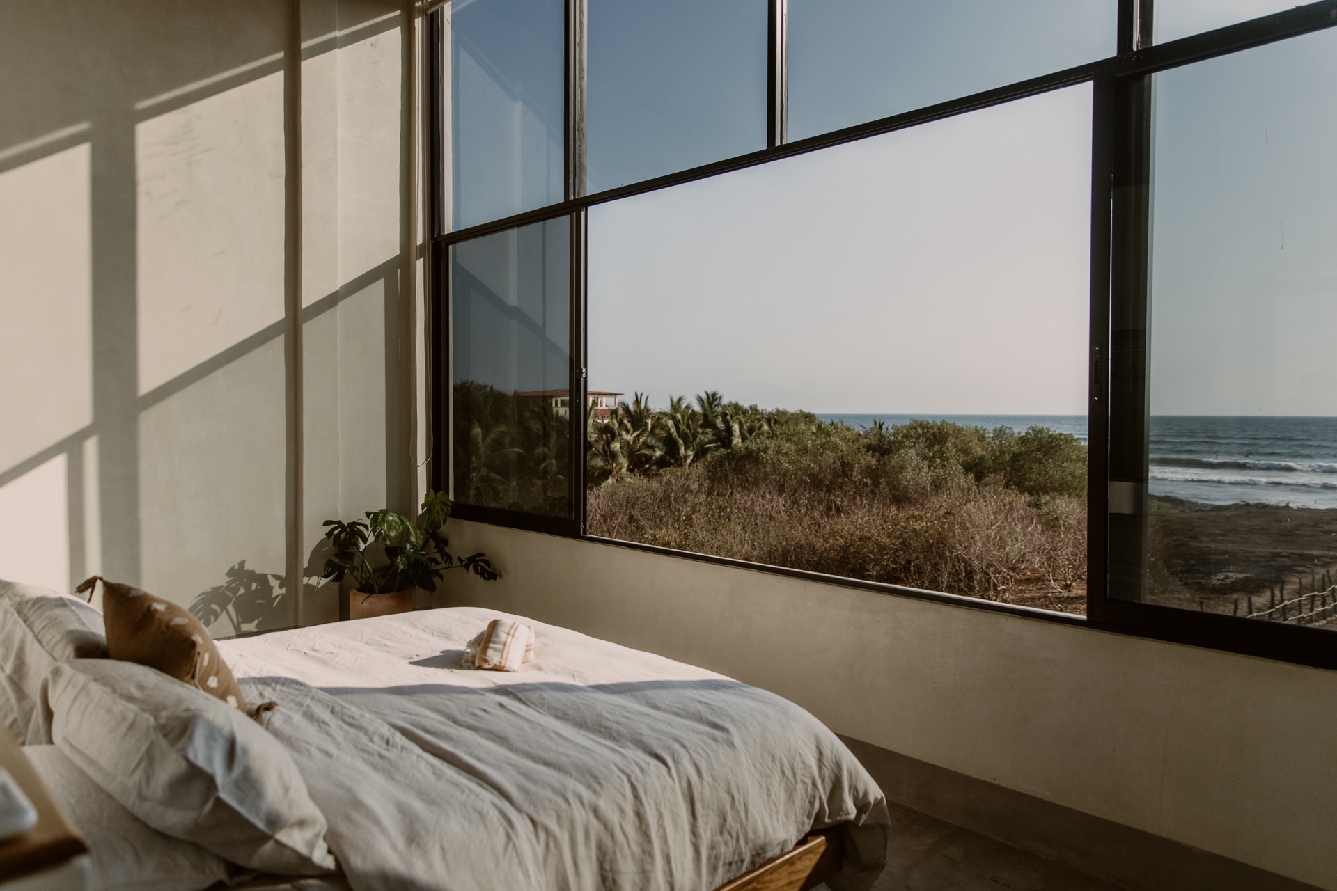 Bedroom with floor-to-ceiling ocean view