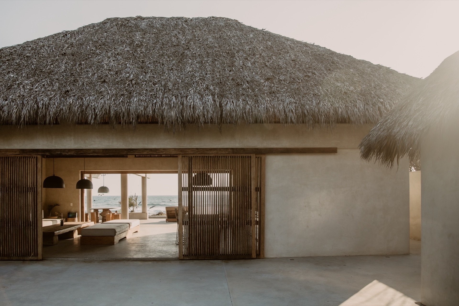 Palapa exterior — thatched roof with warm interior glow