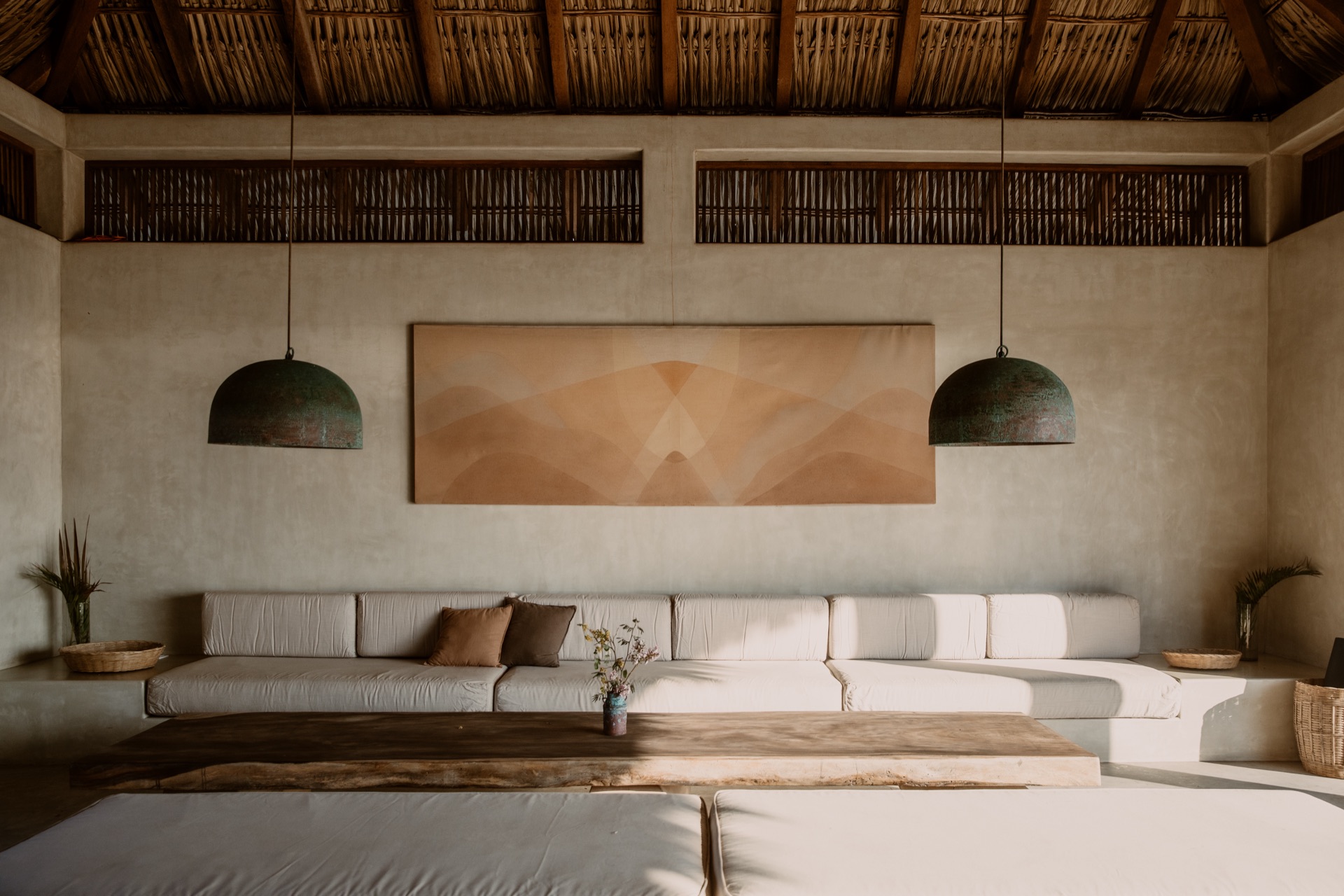 Palapa great room from above — pendants, art, concrete