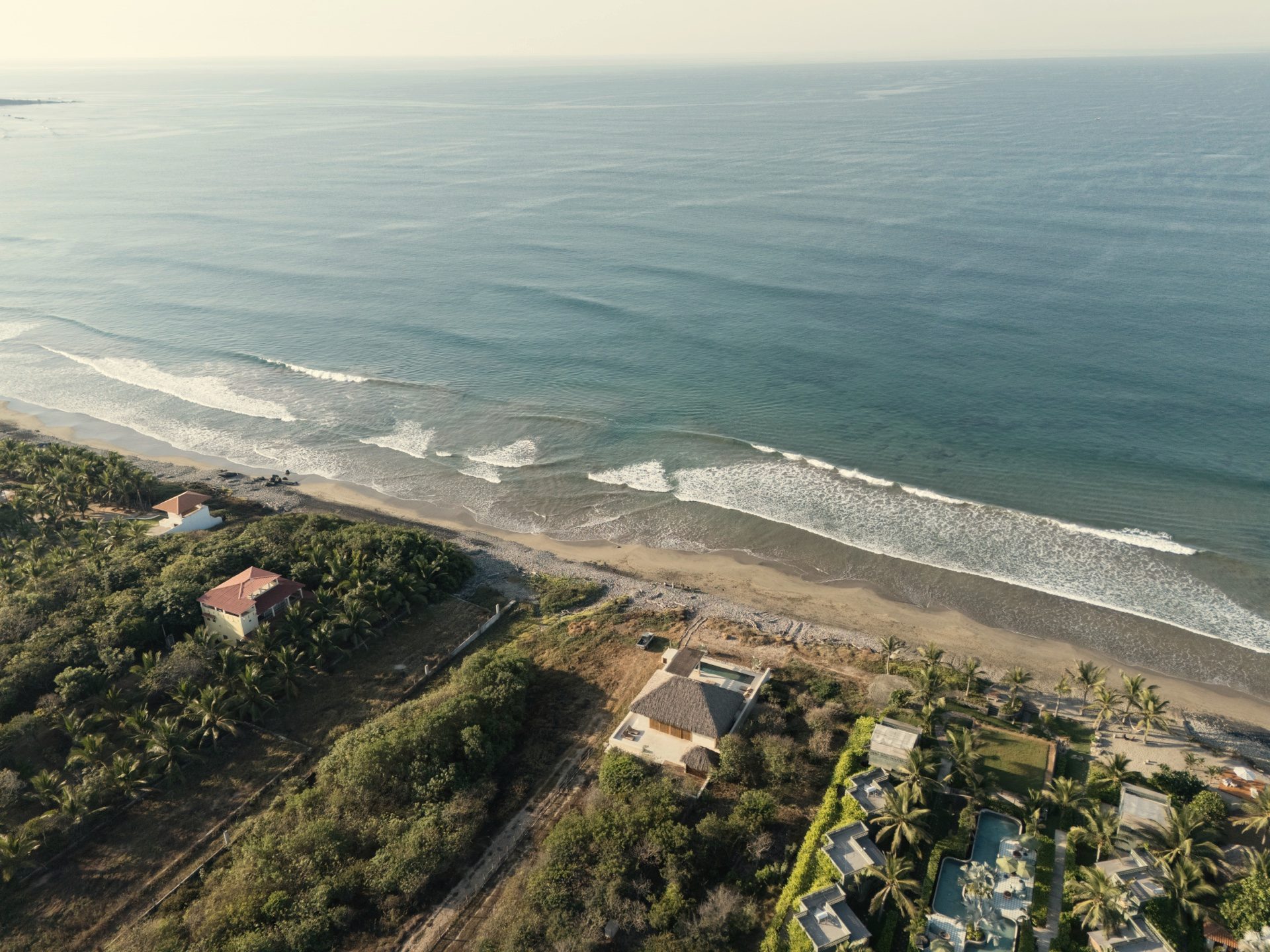 Aerial coastline — Casa Kona beachfront with La Saladita waves