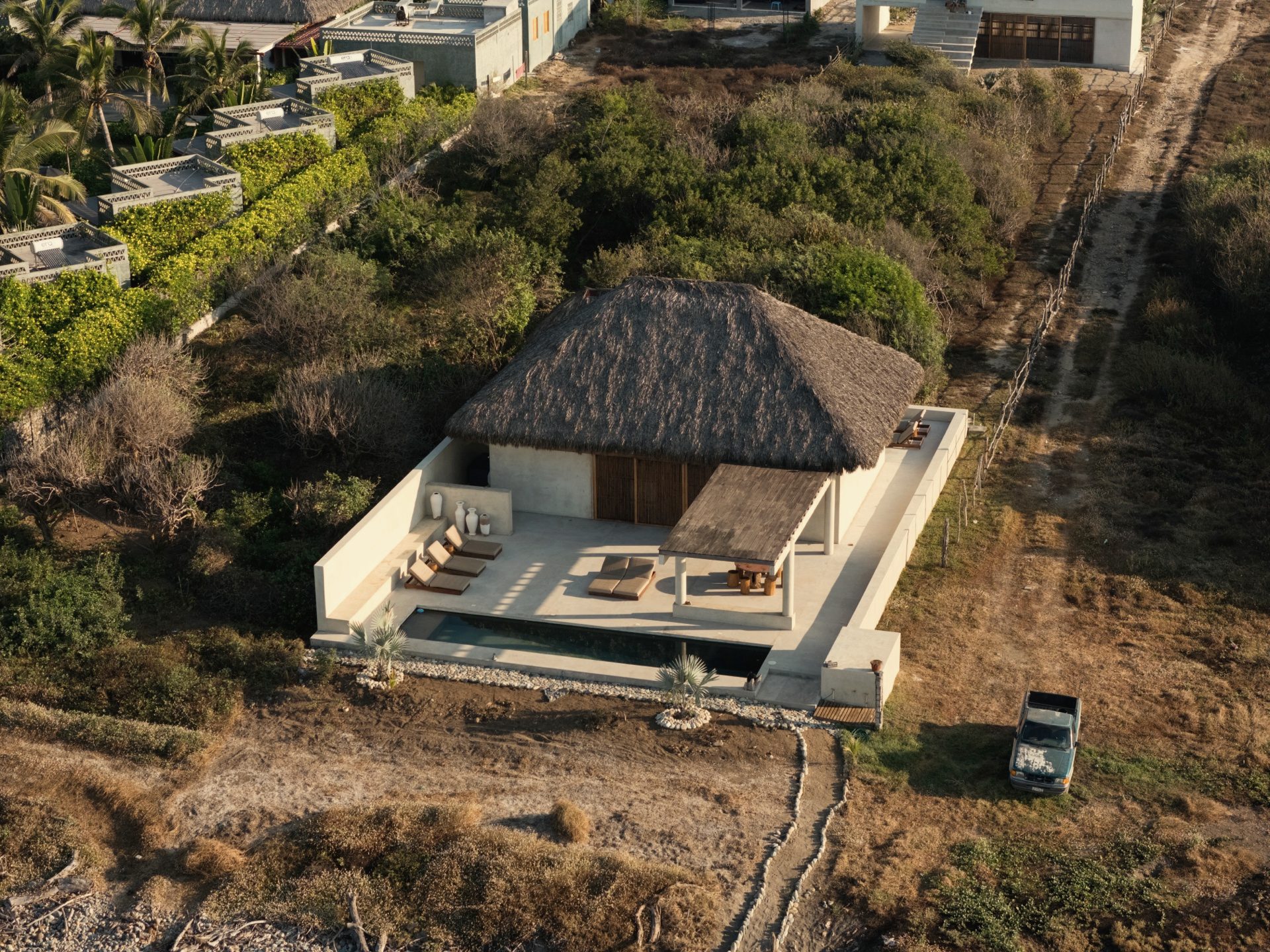Overhead view of Casa Kona — palapa, pool deck and loungers from above